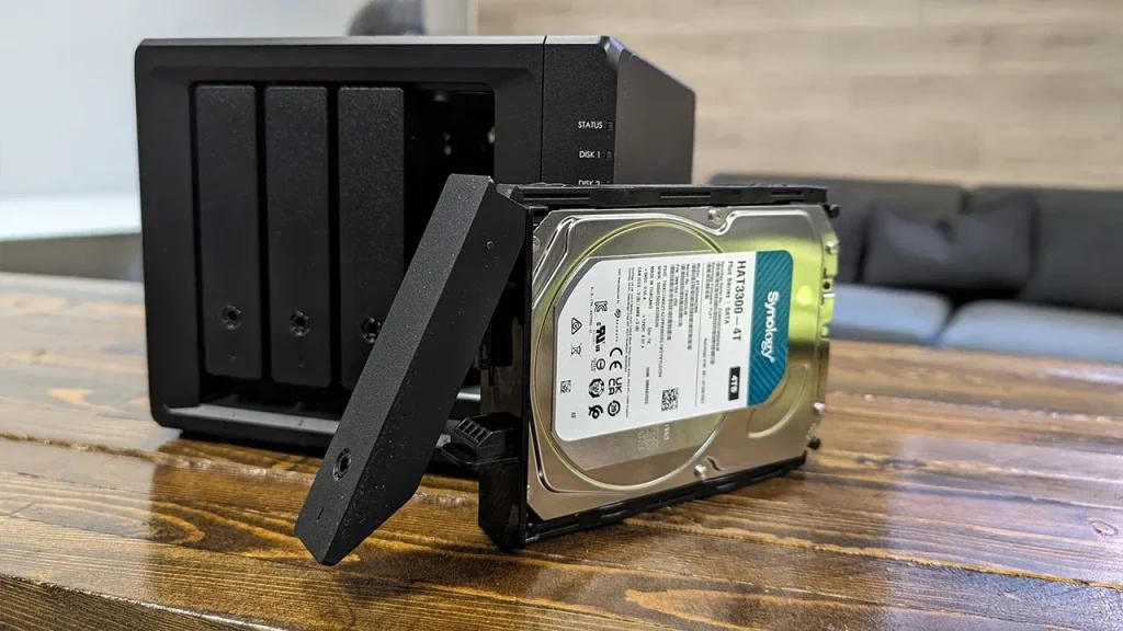 Synology NAS with a 4TB hard disk pulled out in a drive tray.