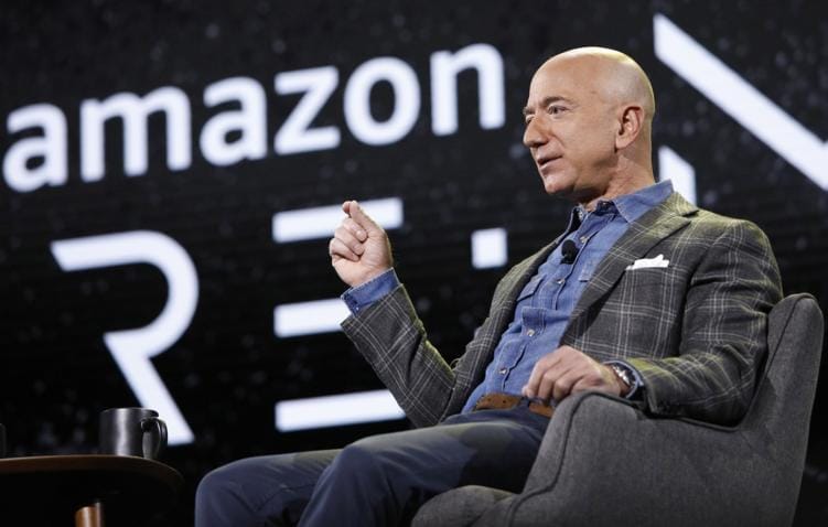 Image of Jeff Bezos speaking at an Amazon Re:Invent event, discussing the company's innovations and technologies.