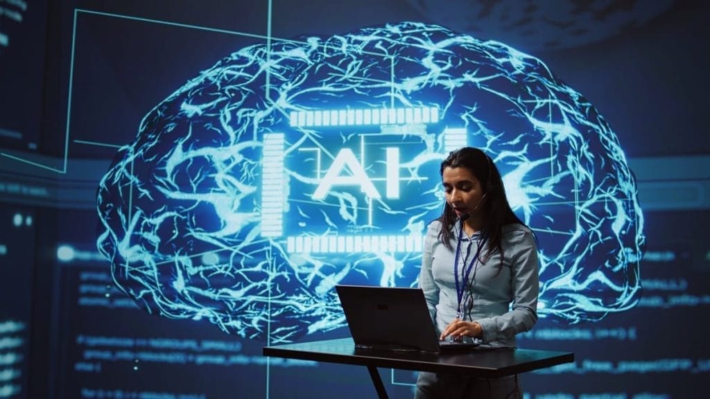 A woman in an office, working on a laptop with AI brain and technology imagery on the screen