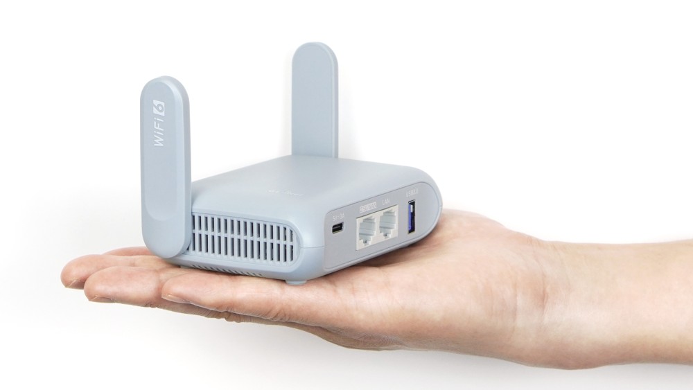 A compact WiFi 6 router held in a hand, emphasizing portability and modern connectivity.