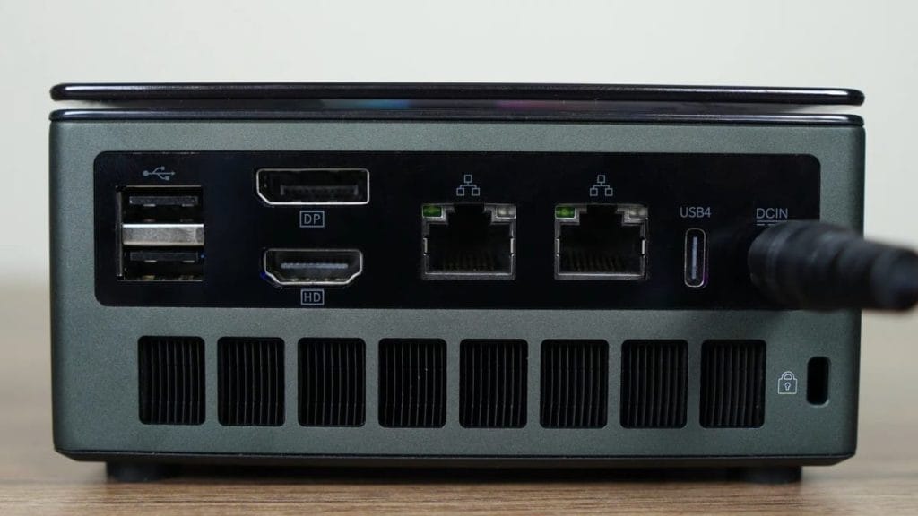 The rear panel of the compact GMKtec K11 computer features USB, HDMI, DisplayPort, and network connectors.