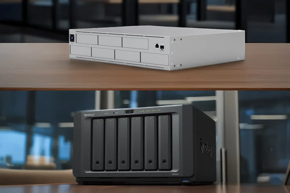 Two network-attached storage devices UniFi UNAS Pro vs Synology on a wooden table, showcasing modern technology for data storage solutions.