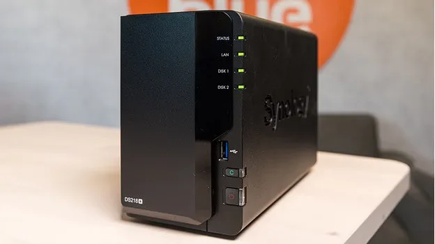 A Synology DiskStation DS218+ NAS with power and status indicators on display.