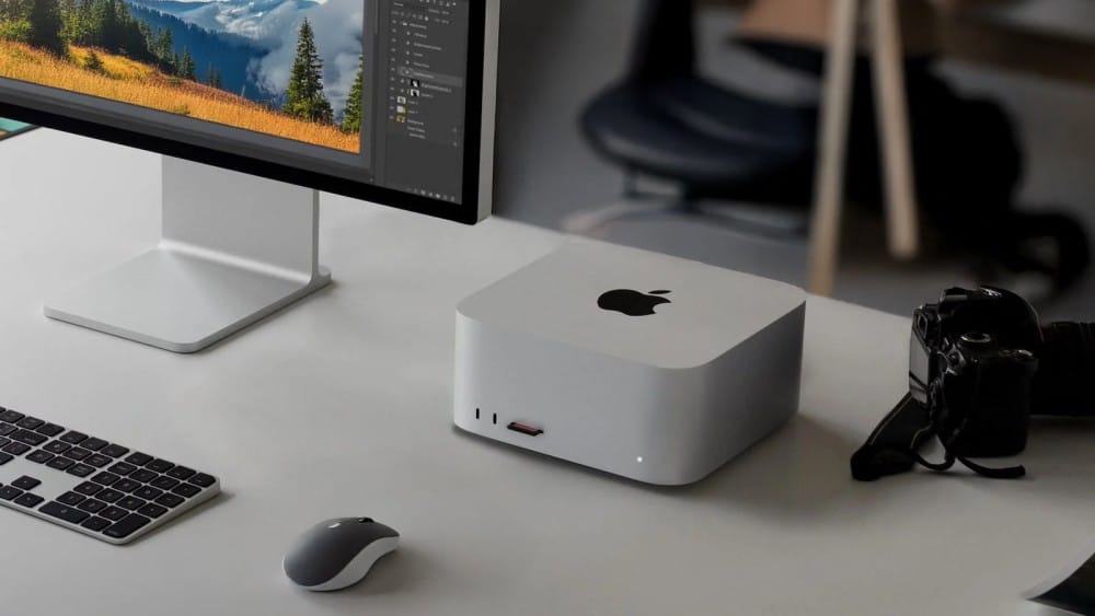 Mac Studio M3 Ultra Tested: Ultimate Power, But for Who? A sleek Apple Mac Studio M3 Ultra desktop setup featuring a monitor, keyboard, and camera on a stylish table.