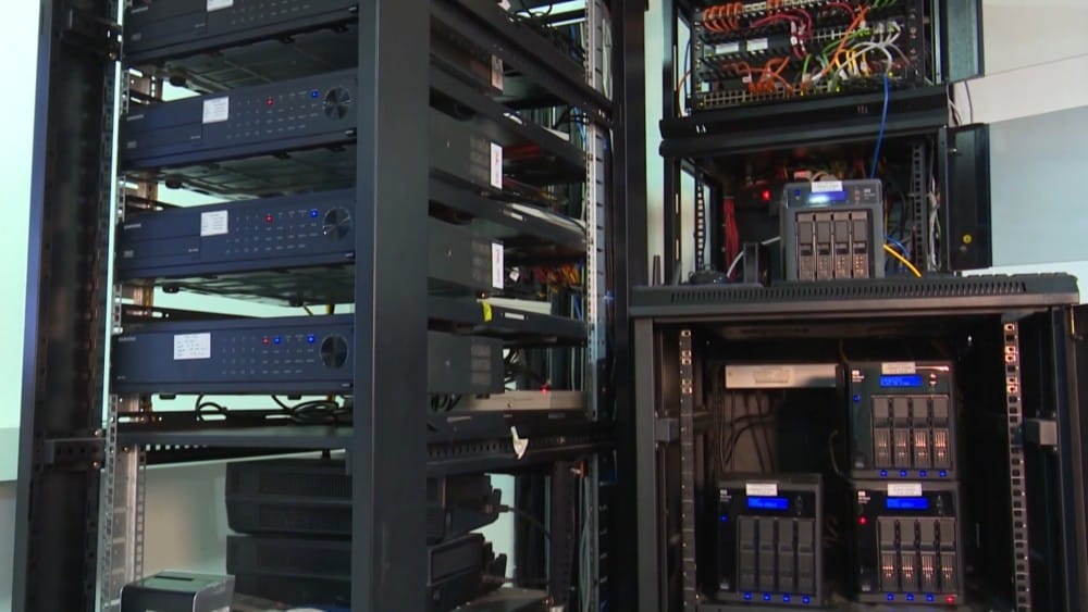 A view of a modern data center showcasing various servers and networking equipment in racks.