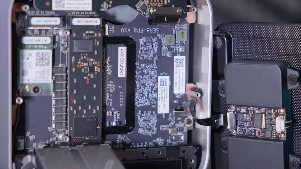 An internal view of electronic components within Beelink SER9 Pro displaying circuit boards, chips, and connectors.