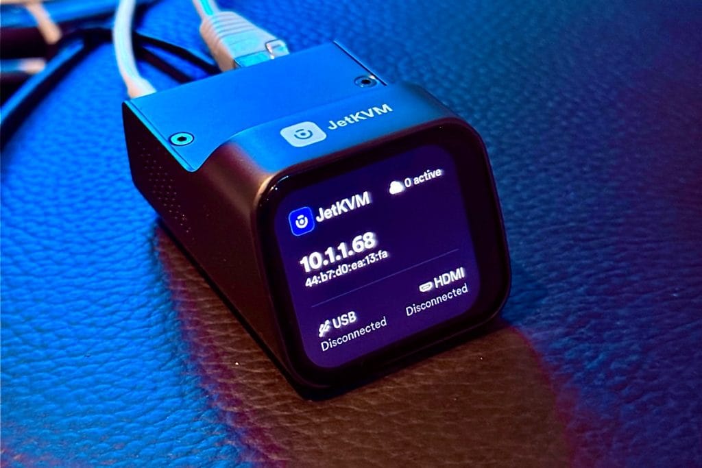 A JetKVM device displaying network status and connections, including USB and HDMI ports.