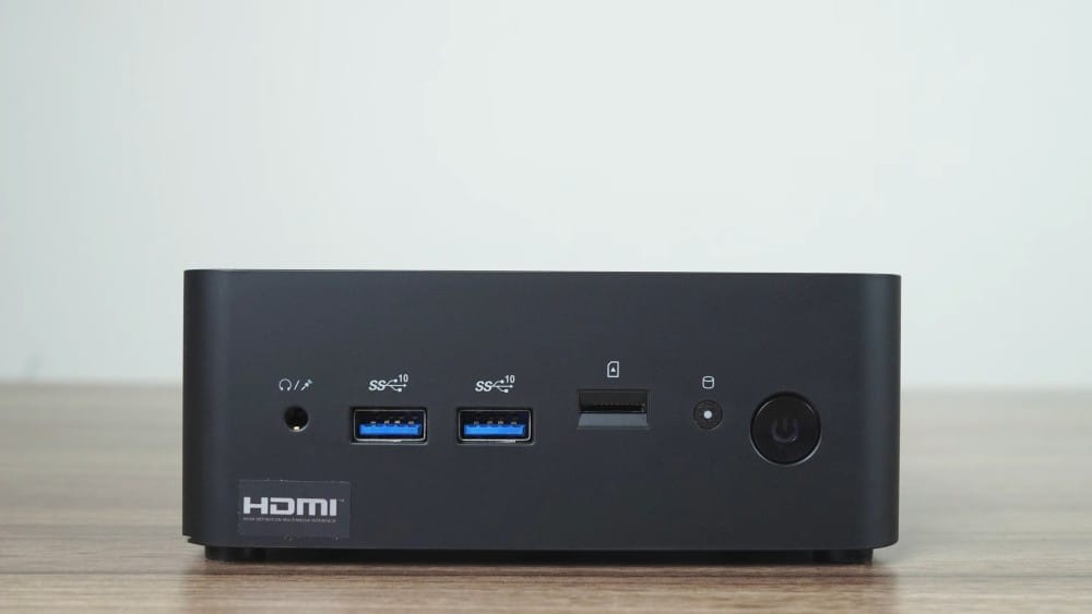 A compact black mini PC with multiple USB ports, HDMI output, and an audio jack, perfect for home or office use.