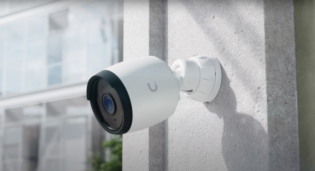 A modern security camera mounted on a wall, showcasing its sleek design and advanced technology.