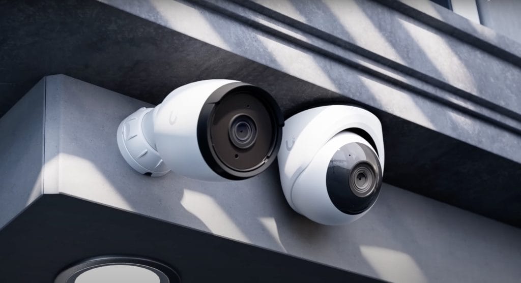 Two security cameras mounted on a wall, showcasing modern surveillance technology.