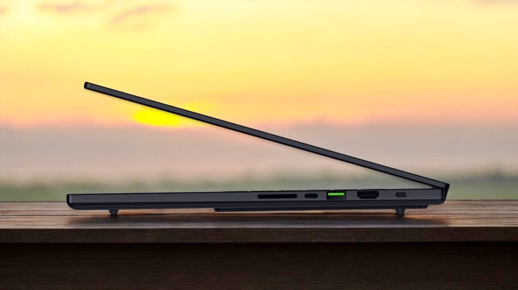 Razer Blade 16 (2025) RTX 5090. A sleek laptop positioned on a wooden surface with a sunset backdrop, showcasing modern design and connectivity options.