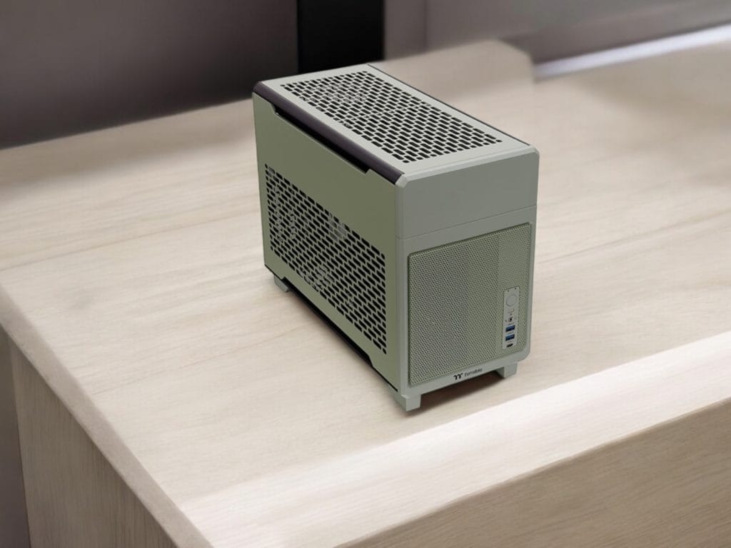 A compact desktop PC with a modern design placed on a wooden table.