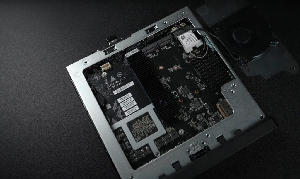 Minisforum MS-A2. Internal view of a compact electronic device showing a circuit board with heat sinks, NVMe slots, and a cooling fan