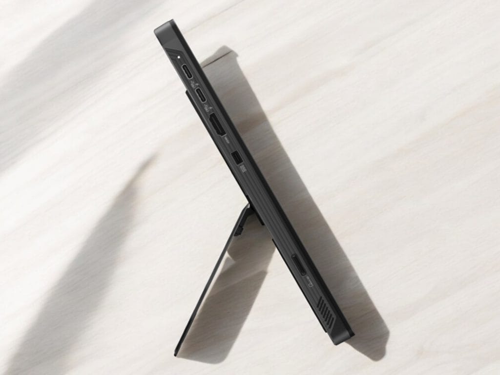 Asus Flow Z13 2025. A sleek tablet with ports and a kickstand positioned on a light wooden surface.