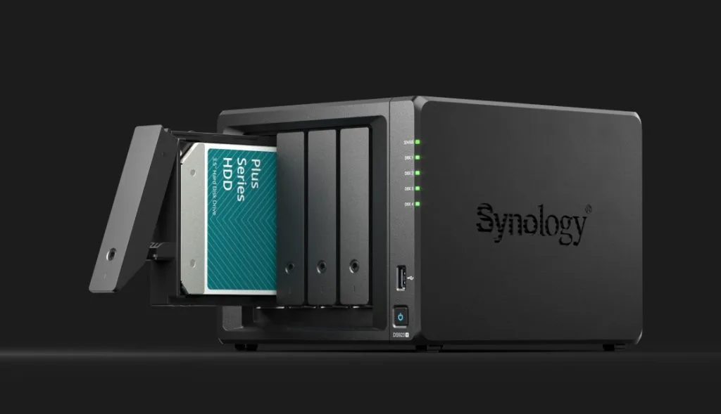 Synology NAS device with a hard disk drive being inserted in the first slot of the four-bay enclosure