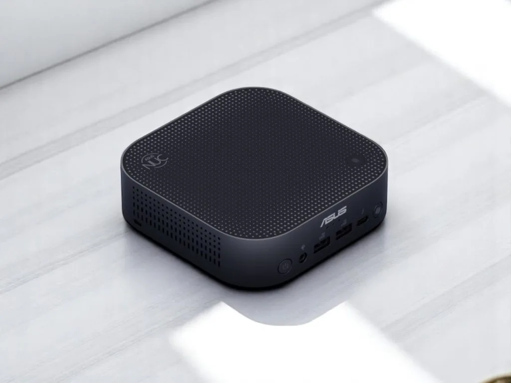 ASUS NUC 14 Pro AI. A compact black ASUS mini PC with USB ports and power button on a light surface